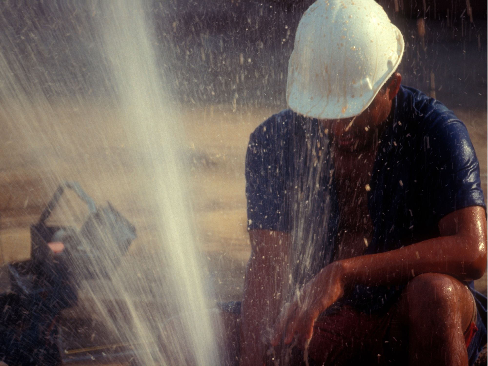 Emergency plumber working near a burst water line