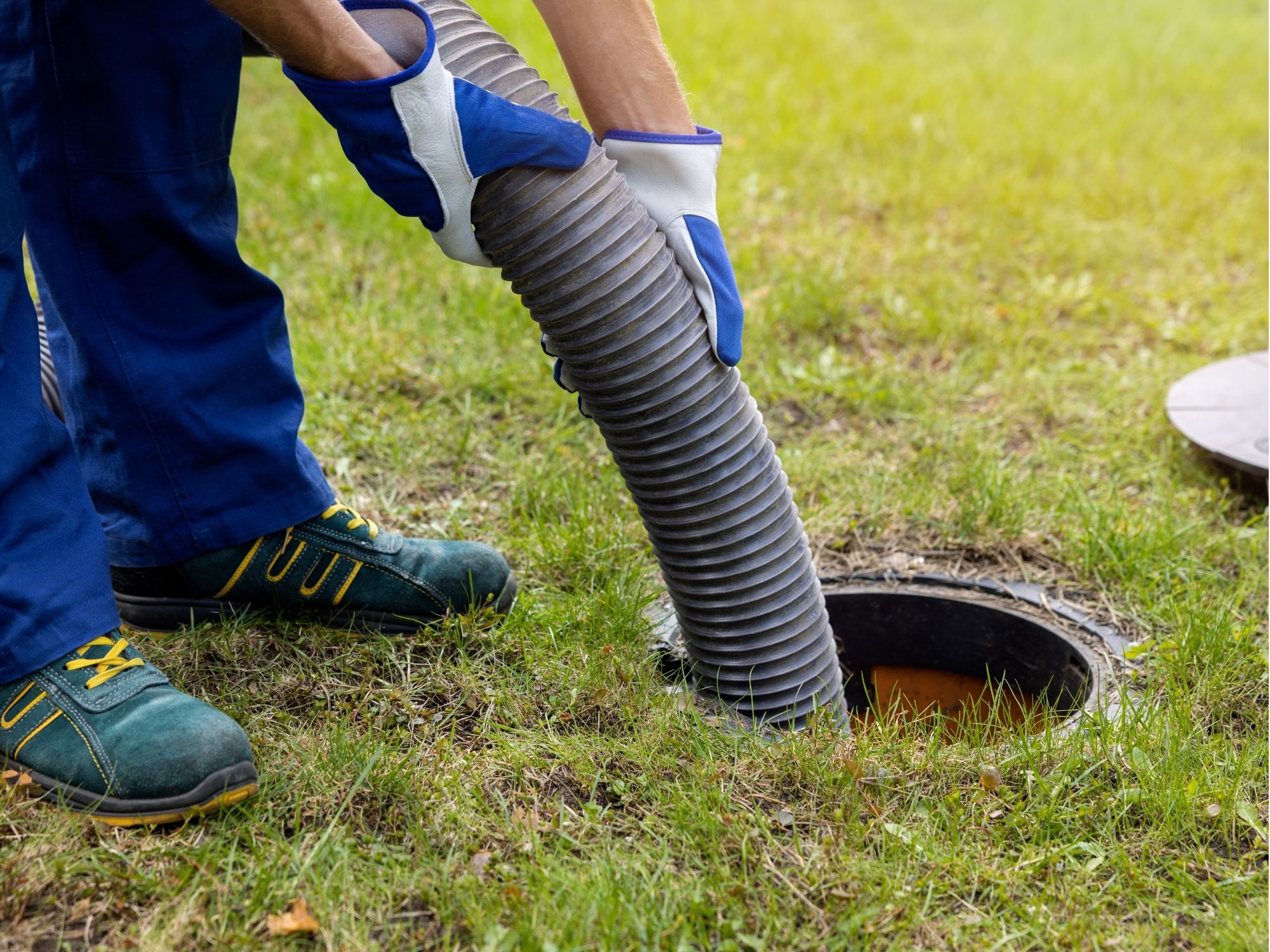 Plumber working on an outdoor drain or sewer line
